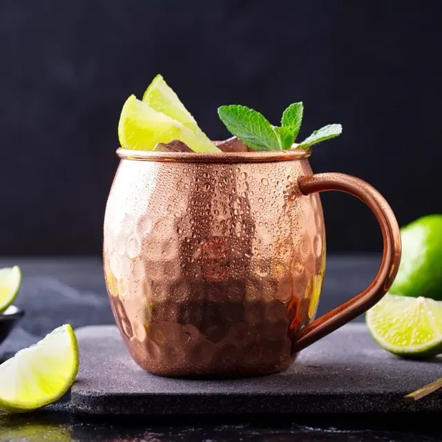 Kyiv Mule served in a copper mug with lime and mint